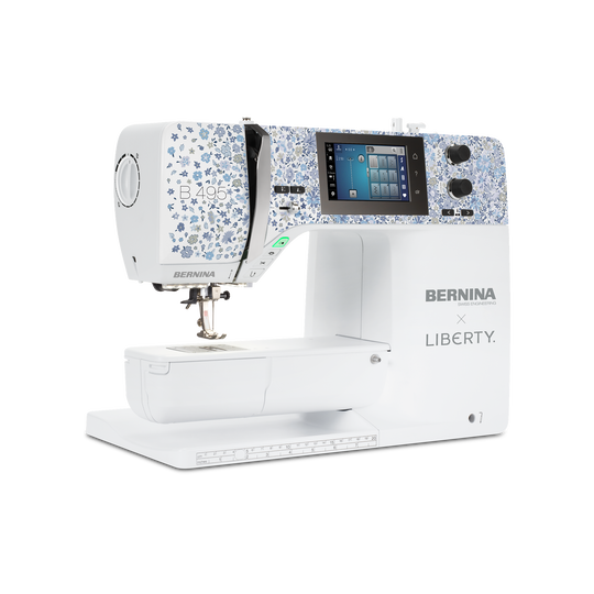 Modern BERNINA LIBERTY sewing machine with white base, blue floral front panel and large color touchscreen for sewing and quilting projects. image number