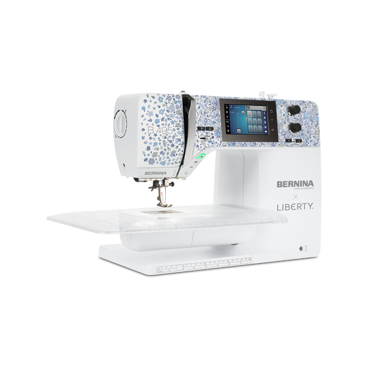 BERNINA L 890 QE overlock and coverstitch machine on extension table, showing free arm, thread stand and color touchscreen for creative sewing image number